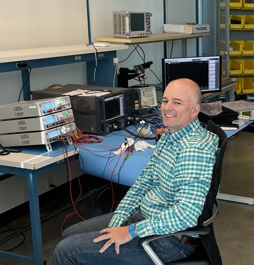 A photo of Michael Roberg, Engineering Fellow, in the lab at mmTron's new office.